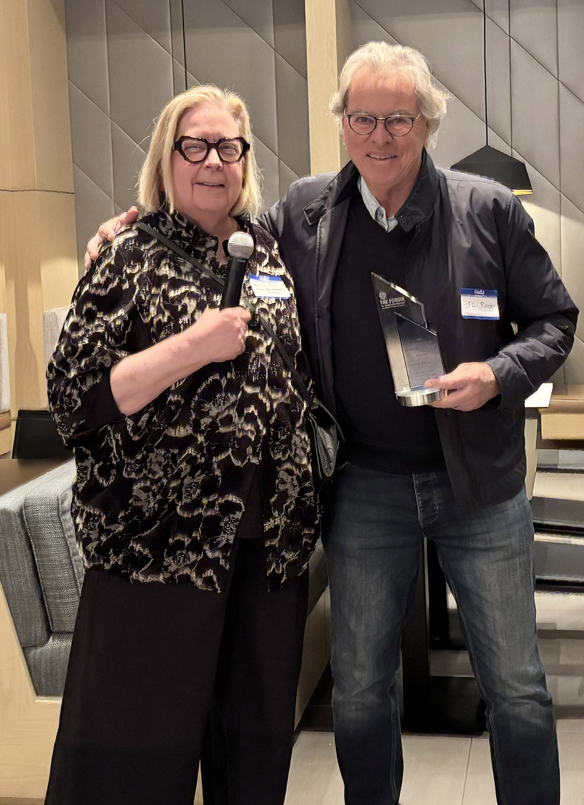 Veronica Miller with Jim Rooney, holding Global Health Catalyst Award